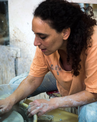 Ayelet working on the potter's wheel