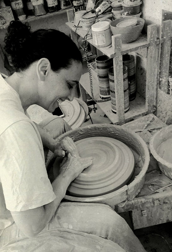 Ayelet working on the potter's wheel